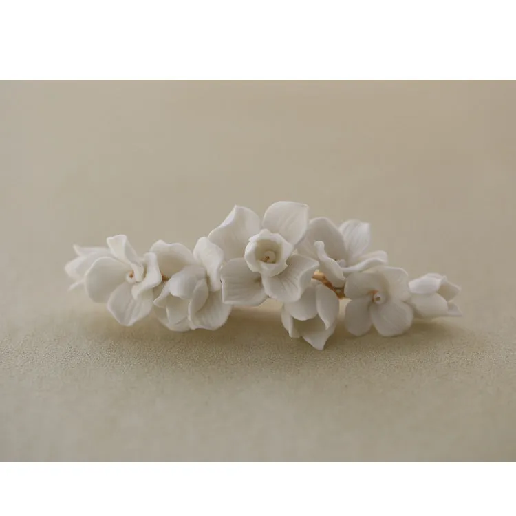 C199. clay flower hair clip, available in gold and silver